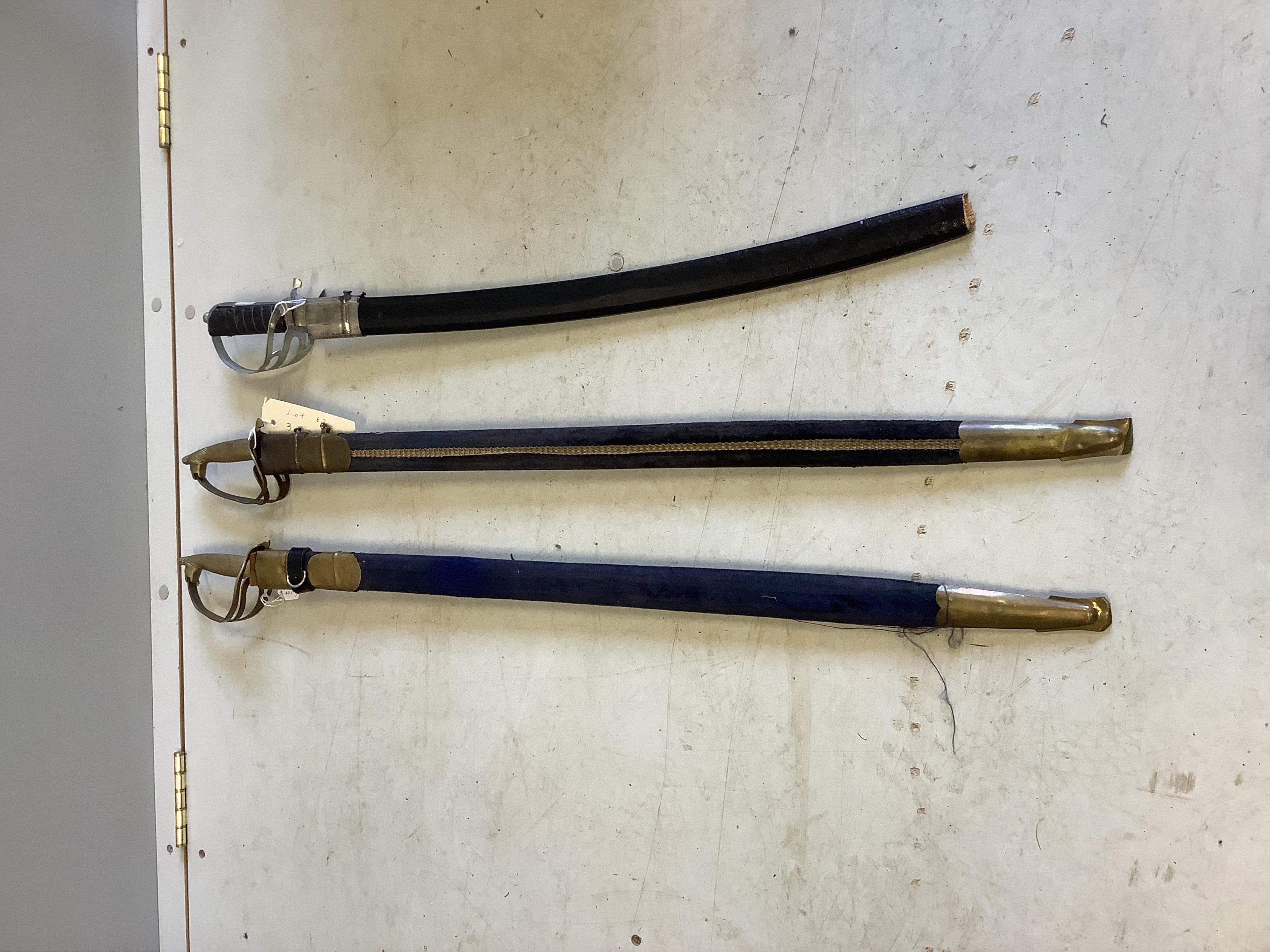 Three reproduction swords in scabbards